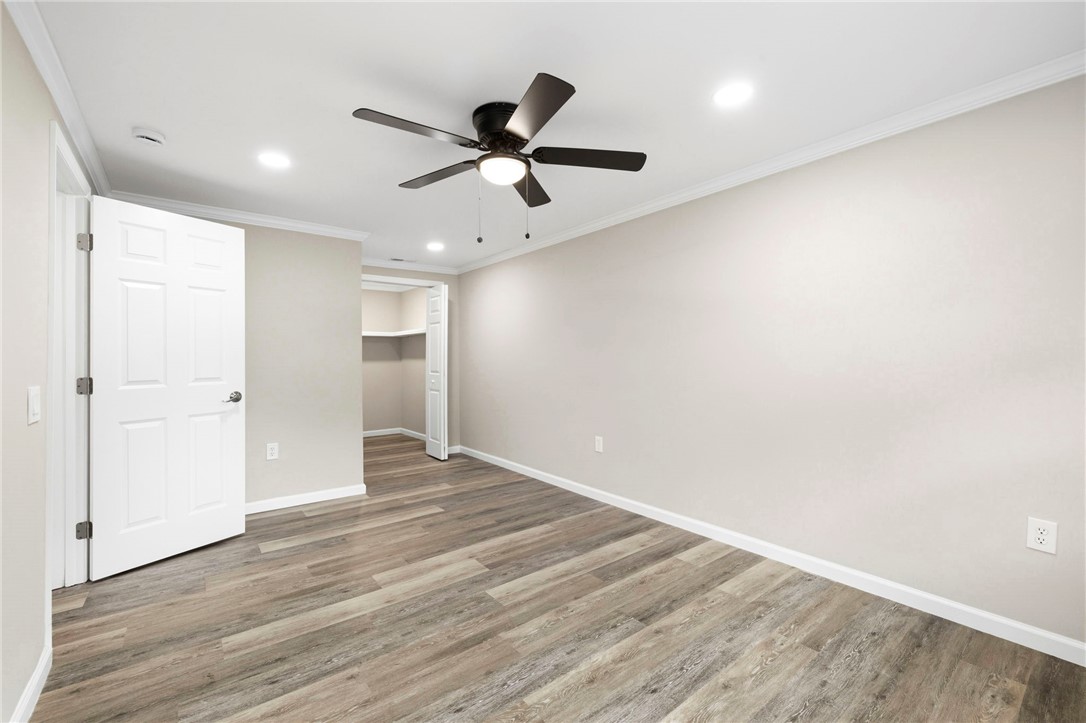 418 Old River Road Pelzer, SC 29669 - Photo 23 of 29 A well-lit bedroom with laminate flooring and ample closet space.