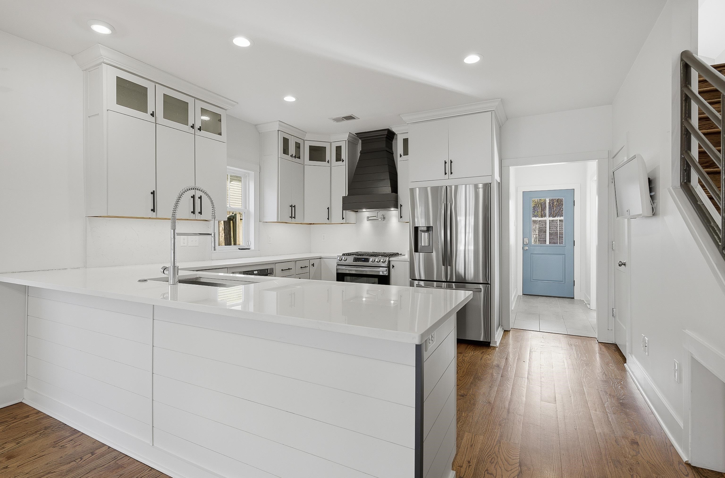 1925 Evelyn Avenue Memphis, TN 38104 - Photo 23 of 30 a kitchen with stainless steel appliances granite countertop a refrigerator sink and white cabinets
