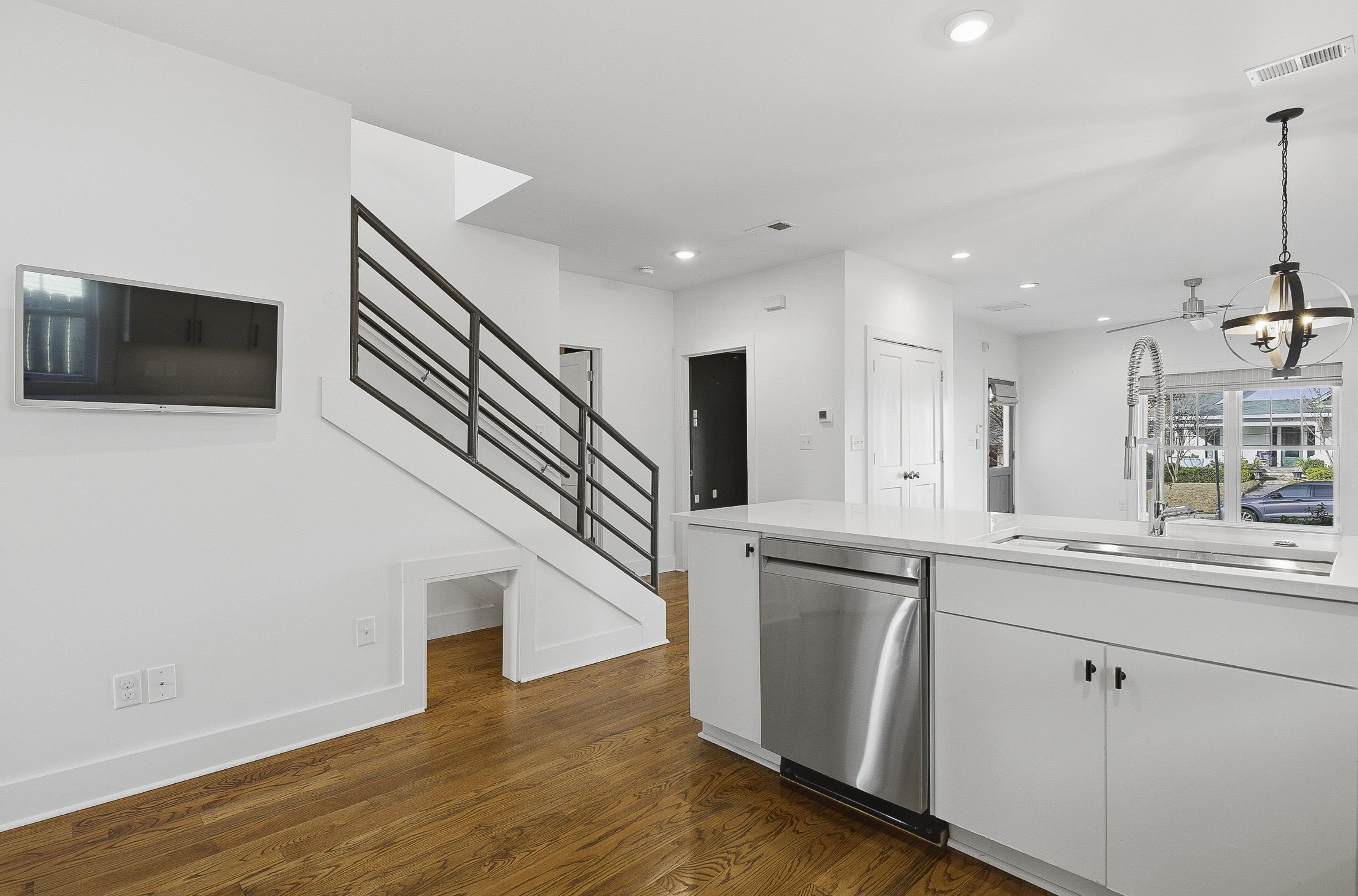 1925 Evelyn Avenue Memphis, TN 38104 - Photo 25 of 30 a kitchen with stainless steel appliances granite countertop a sink a microwave a refrigerator and white cabinets with wooden floor