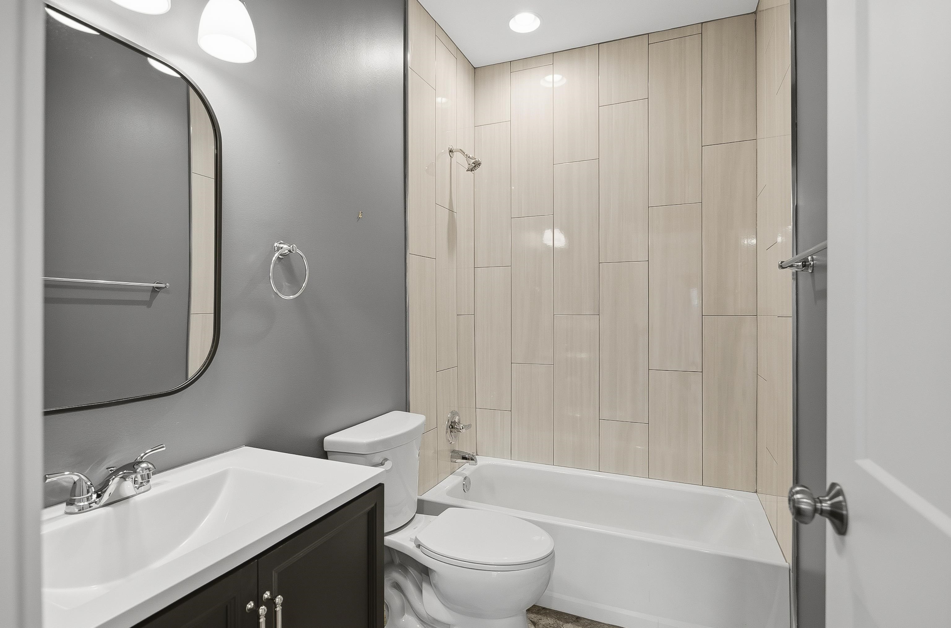 1925 Evelyn Avenue Memphis, TN 38104 - Photo 6 of 30 a bathroom with a double vanity sink toilet mirror and shower