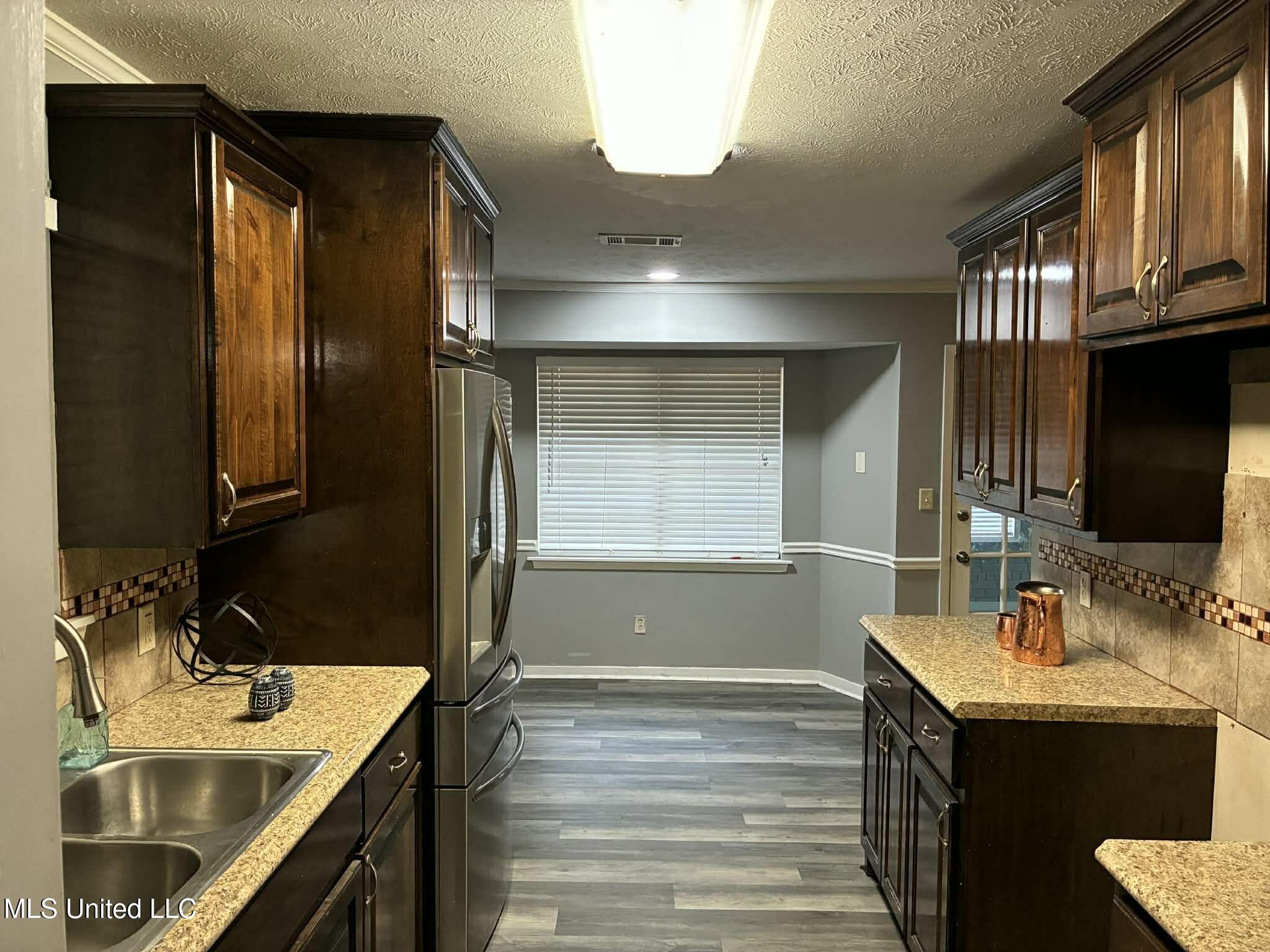 228 Mikell Street Jackson, MS 39212 - Photo 10 of 29 KITNCHEN LEADING TO DINNING ROOM