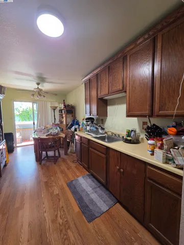 a kitchen with lots of counter top space and wooden floor