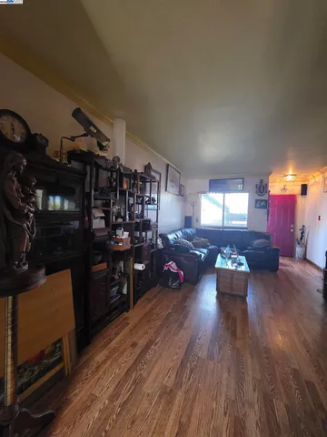 a living room with lots of furniture and wooden floor