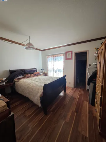 a bedroom with a bed and a large mirror