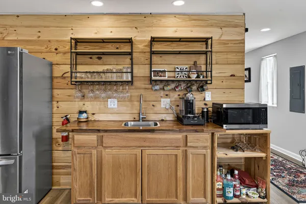 a walk in closet with wooden floor