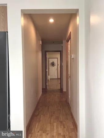 a view of a hallway with a wooden door