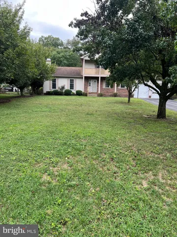 a view of house with yard