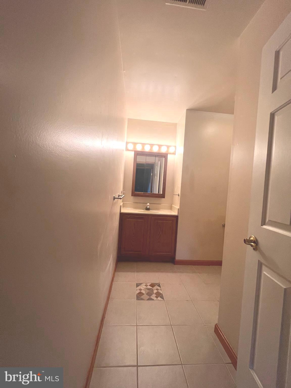 30883 Ward Road Salisbury, MD 21804 - Photo 28 of 34 a bathroom with a sink a mirror and a toilet