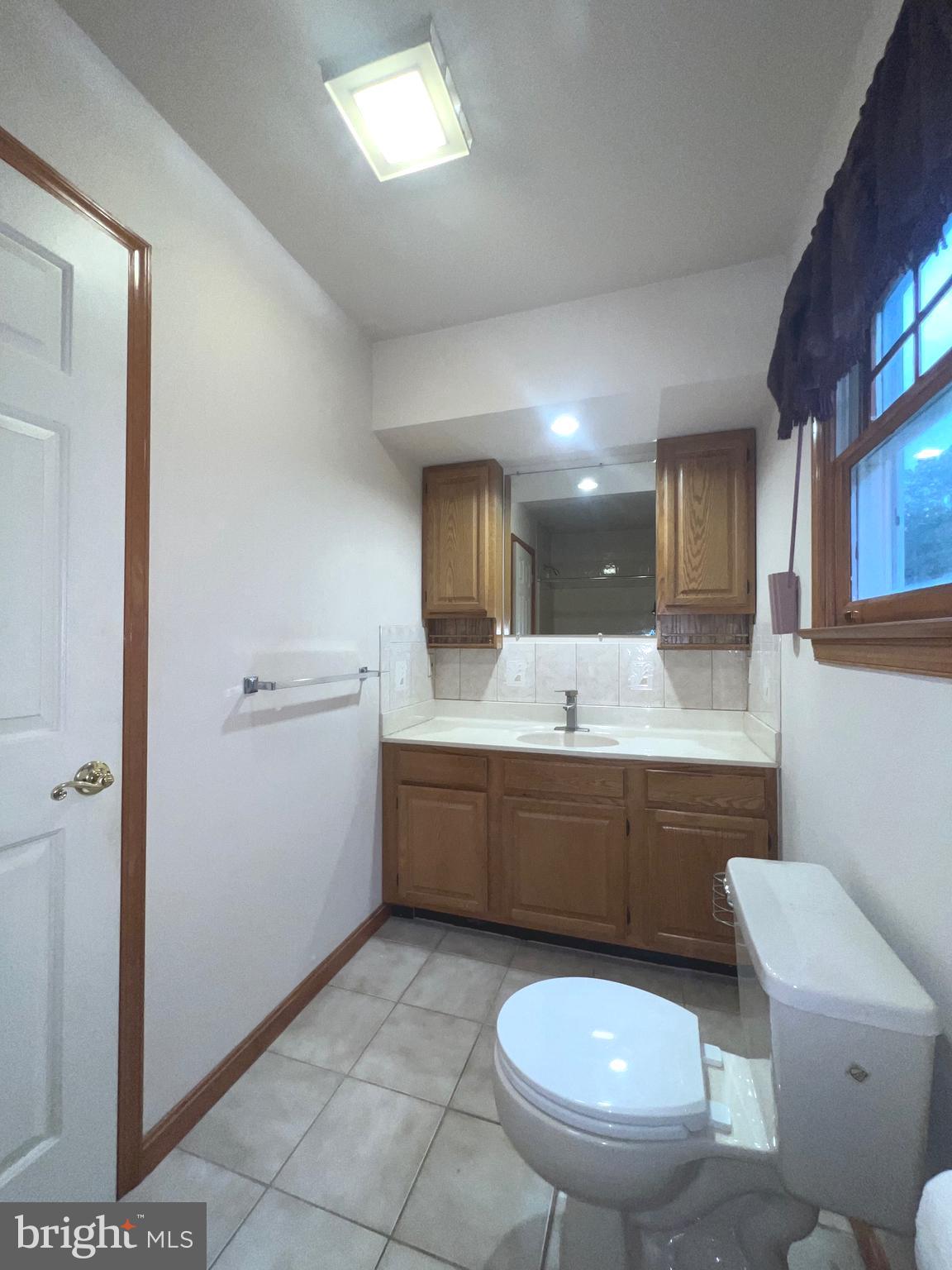 30883 Ward Road Salisbury, MD 21804 - Photo 33 of 34 a bathroom with a toilet a sink and mirror