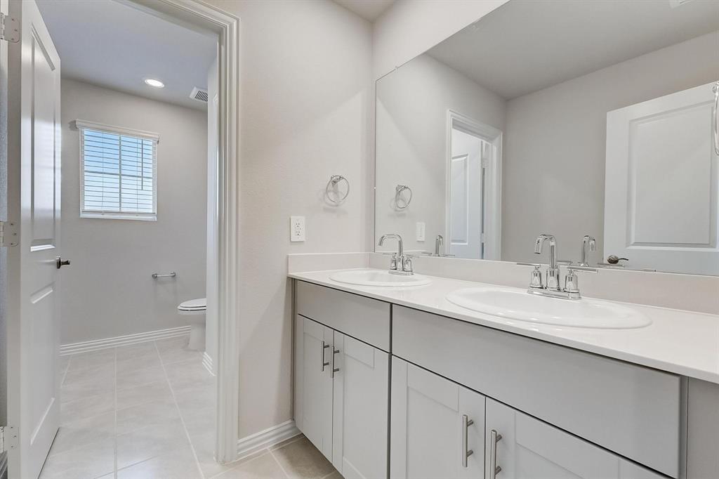 1405 Winters Way McKinney, TX 75071 - Photo 20 of 32 Bathroom featuring tile patterned floors, toilet, and vanity