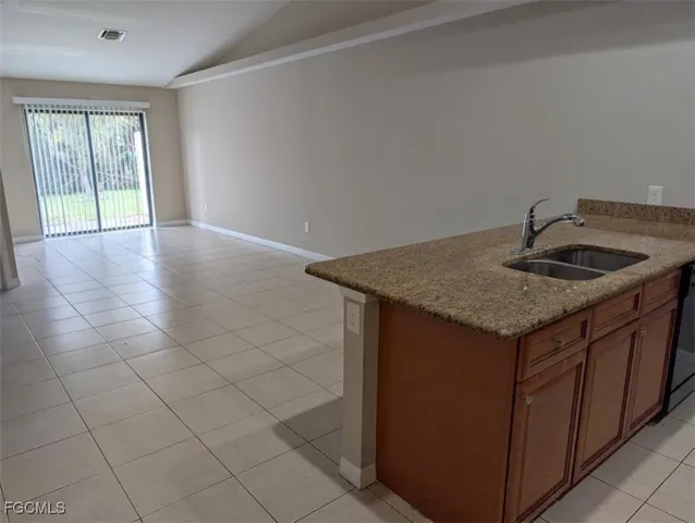 a kitchen with a sink cabinets and wooden floor