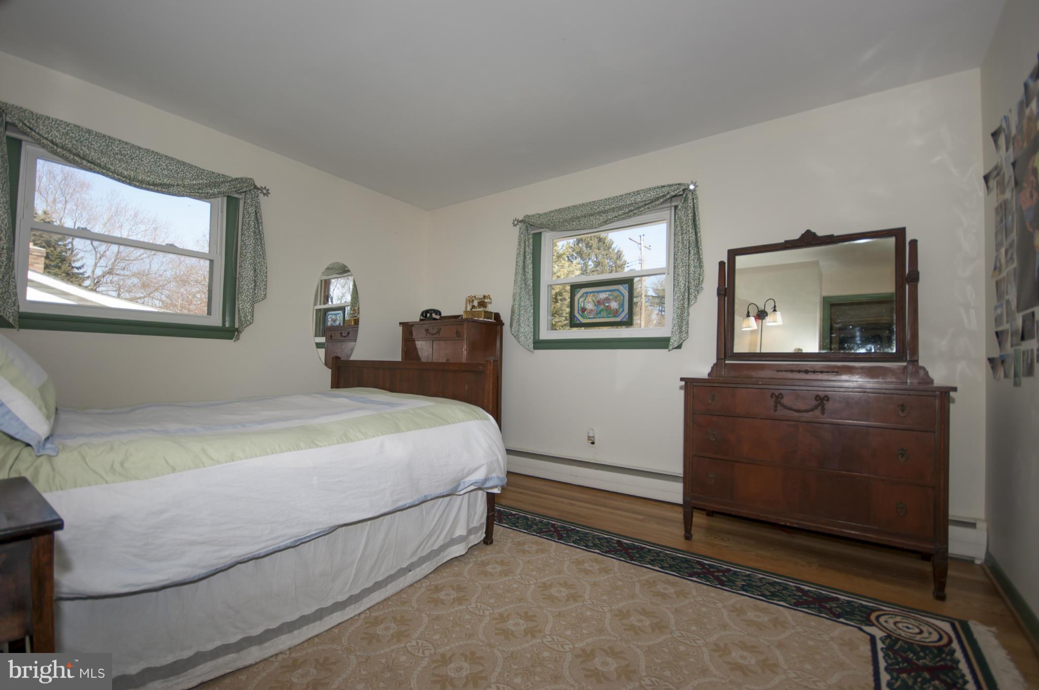 14612 Sturtevant Road Silver Spring, MD 20905 - Photo 12 of 22 a bedroom with a bed and a dresser
