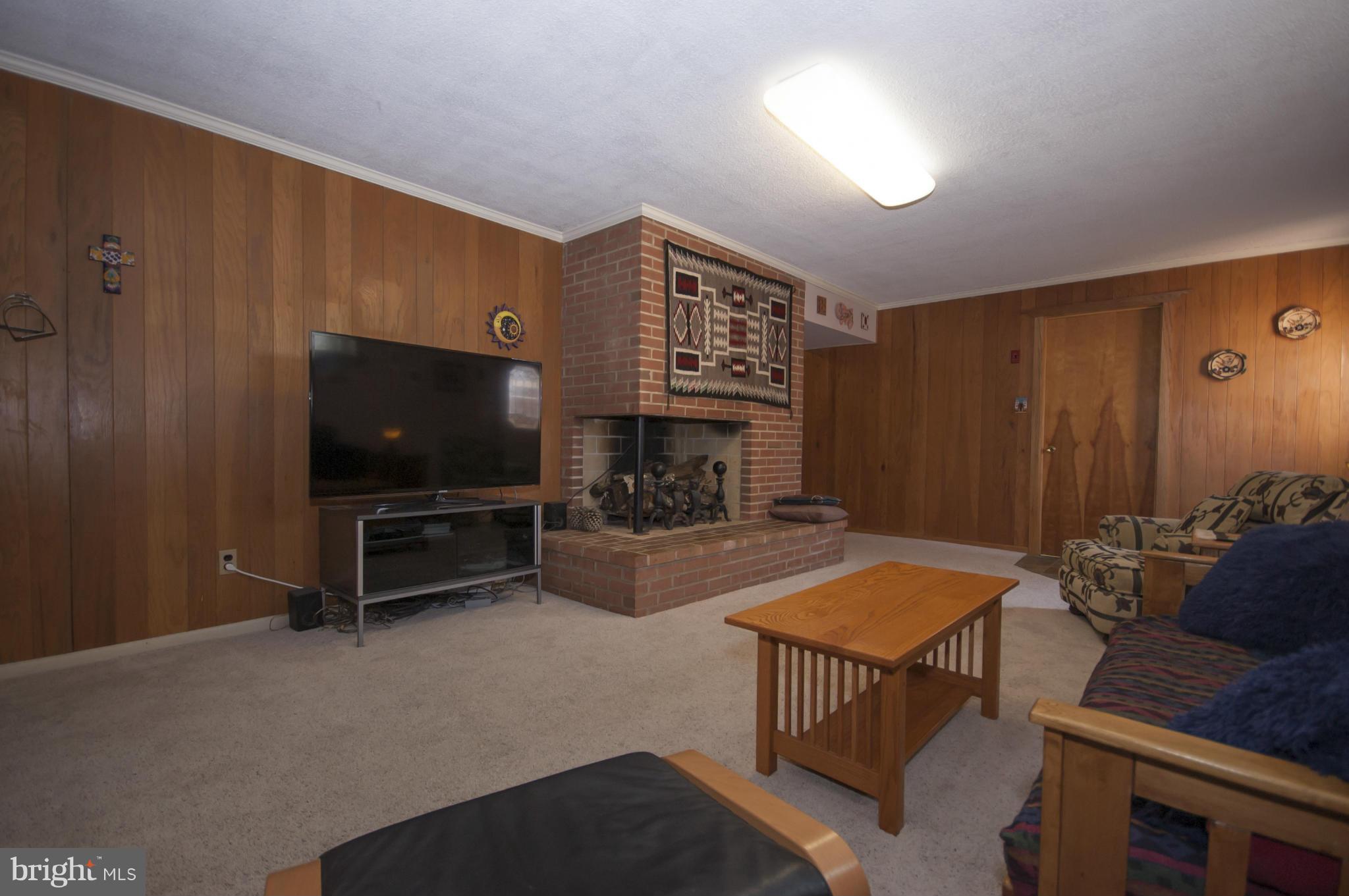 14612 Sturtevant Road Silver Spring, MD 20905 - Photo 16 of 22 a living room with furniture and a flat screen tv