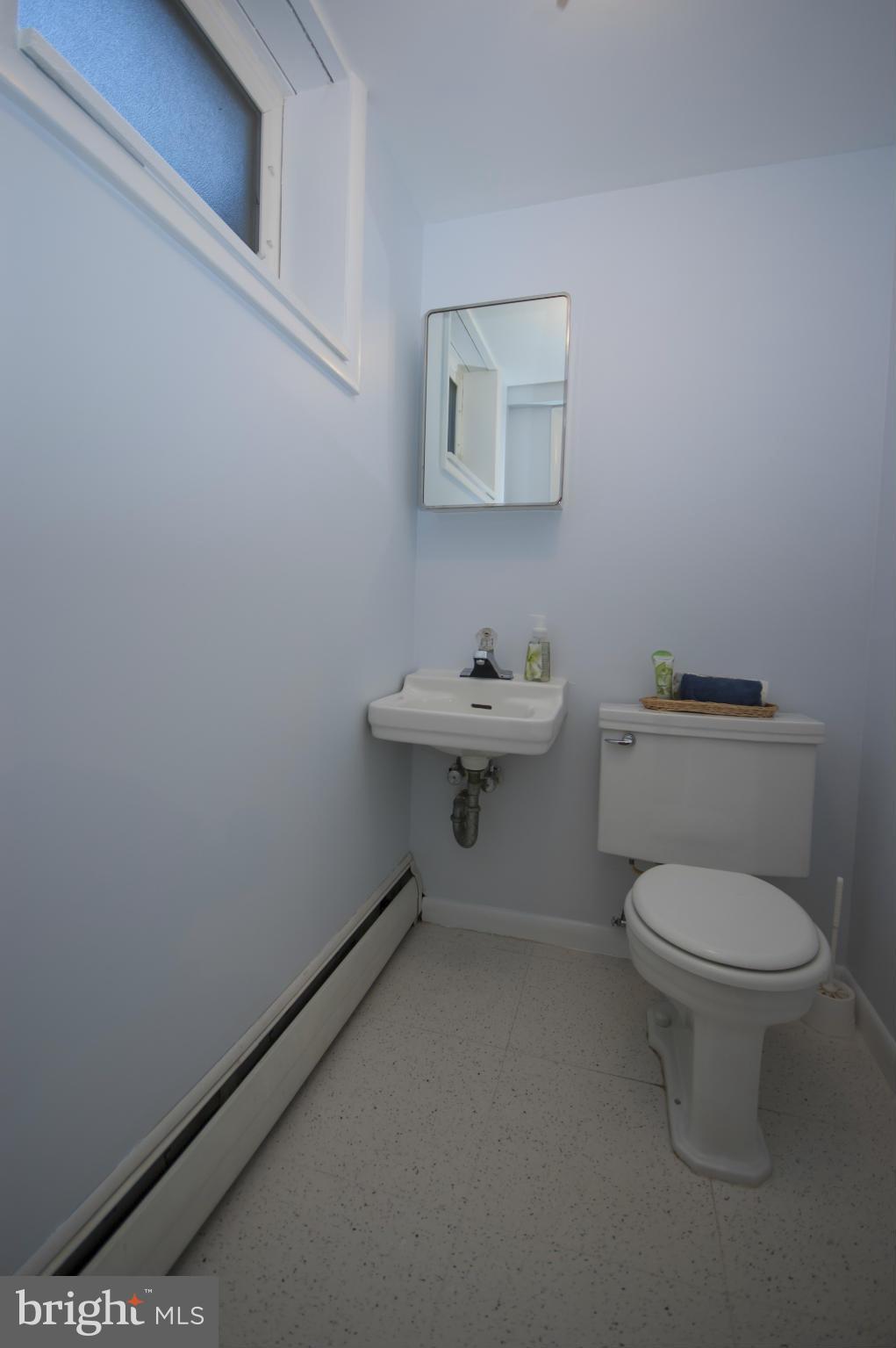 14612 Sturtevant Road Silver Spring, MD 20905 - Photo 19 of 22 a bathroom with a toilet sink and mirror