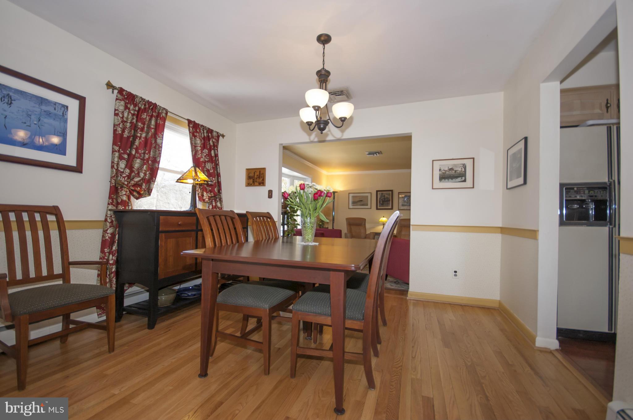 14612 Sturtevant Road Silver Spring, MD 20905 - Photo 3 of 22 a view of a dining room with furniture wooden floor and chandelier
