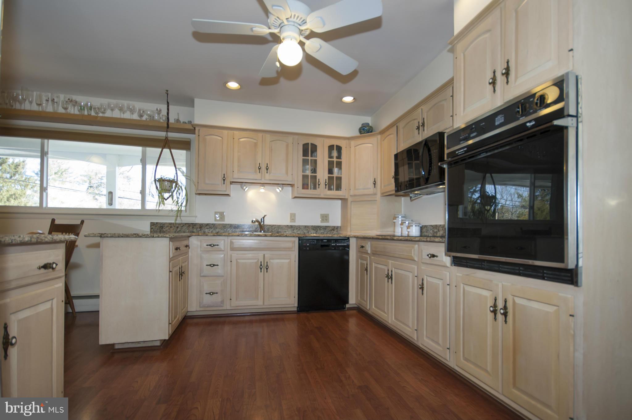 14612 Sturtevant Road Silver Spring, MD 20905 - Photo 5 of 22 a kitchen with granite countertop cabinets stainless steel appliances a sink and a window