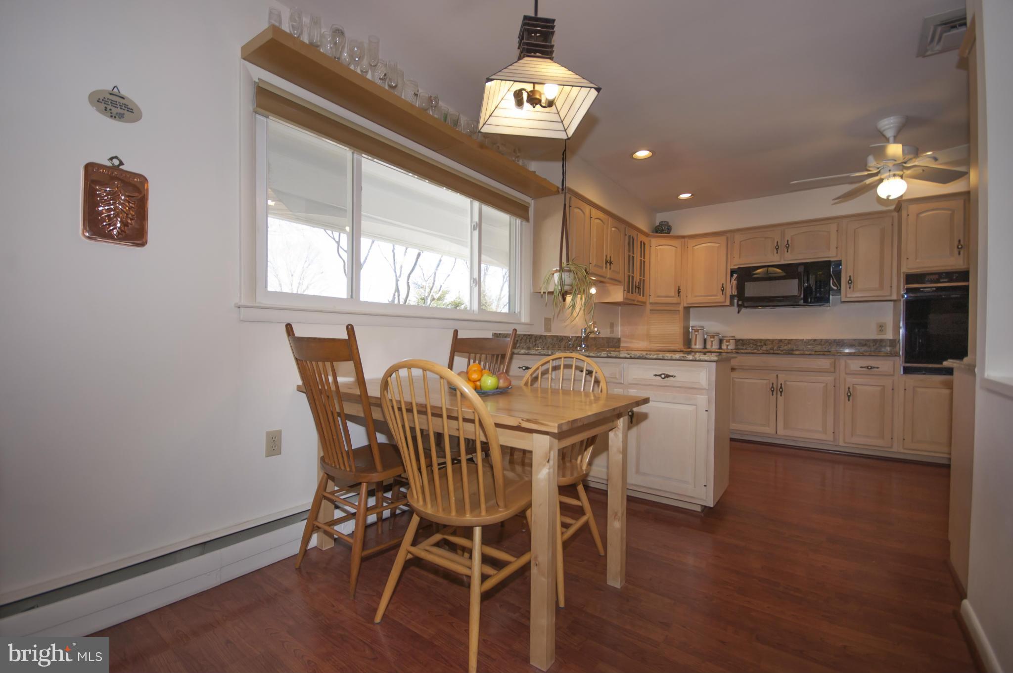 14612 Sturtevant Road Silver Spring, MD 20905 - Photo 6 of 22 a view of a dining room with furniture window and wooden floor