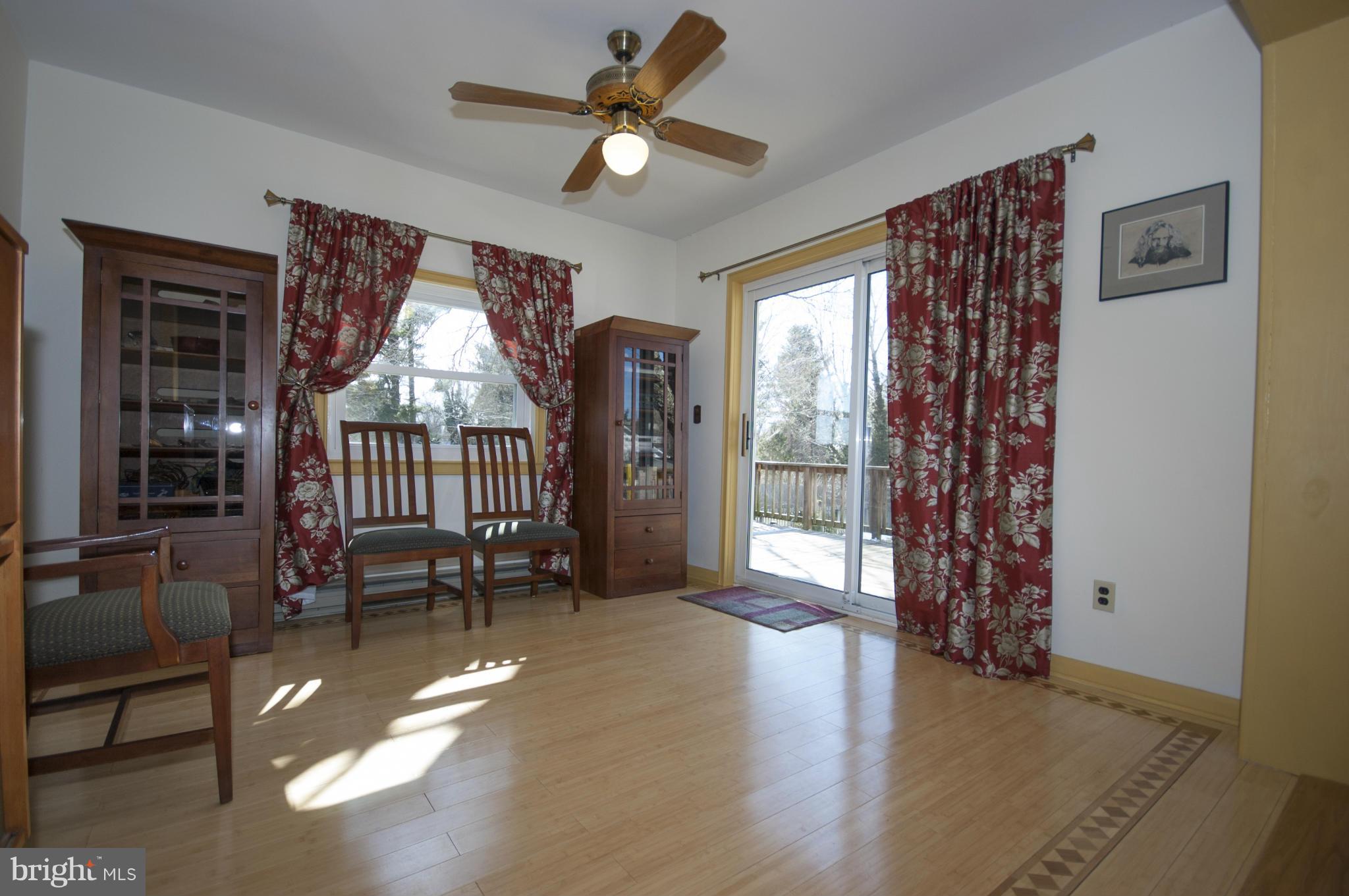 14612 Sturtevant Road Silver Spring, MD 20905 - Photo 8 of 22 a view of a livingroom with furniture window wooden floor and a ceiling fan