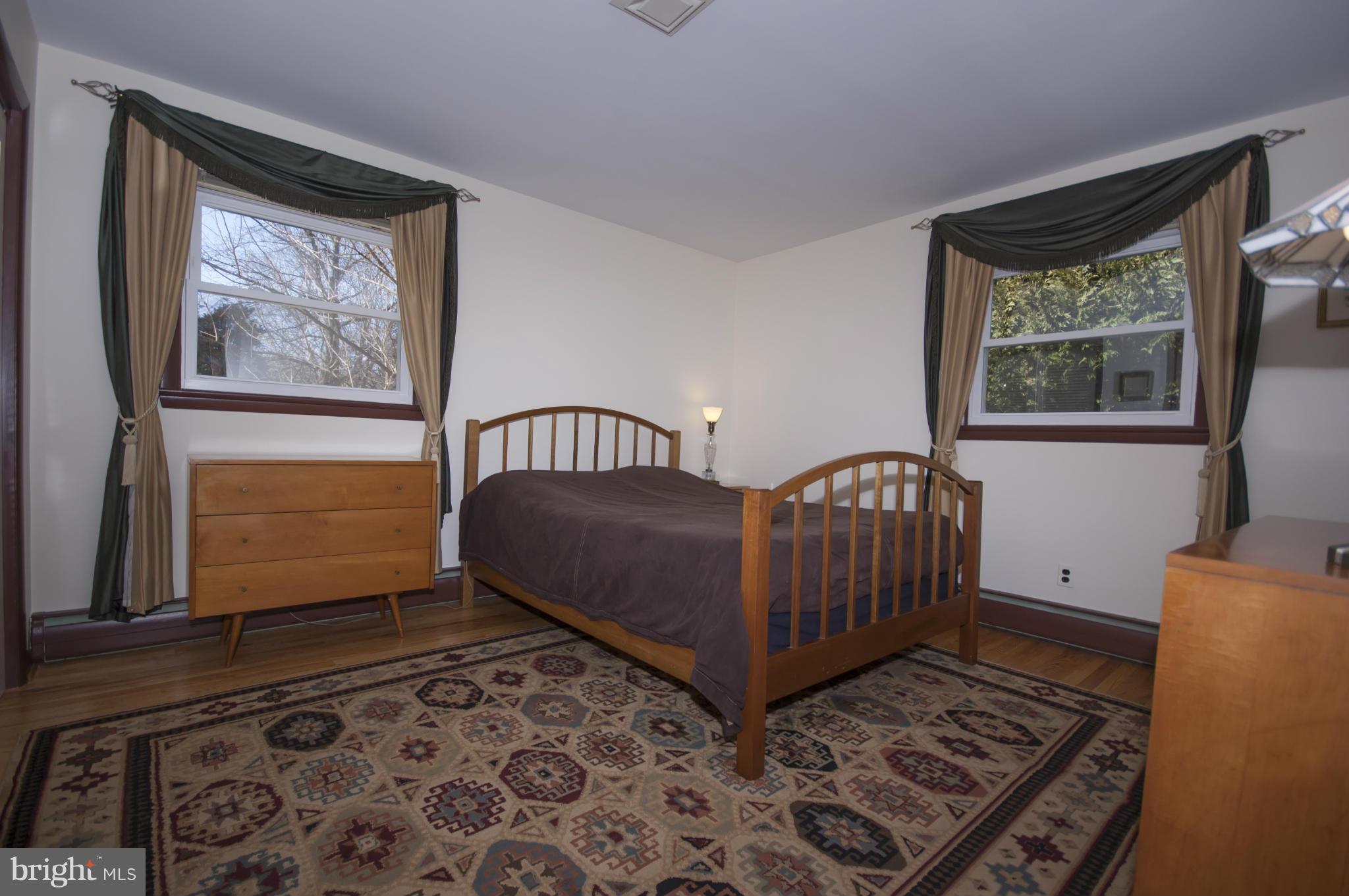 14612 Sturtevant Road Silver Spring, MD 20905 - Photo 10 of 22 a bedroom with a bed and wooden floor