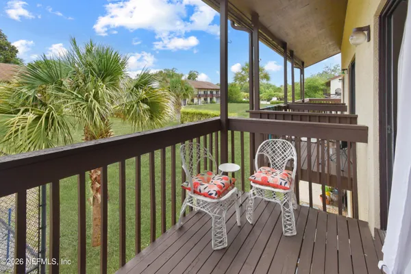 a view of a balcony with wooden floor