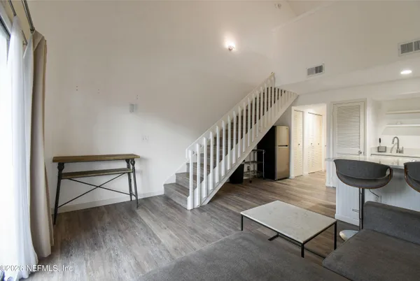 a view of entryway and hall with wooden floor