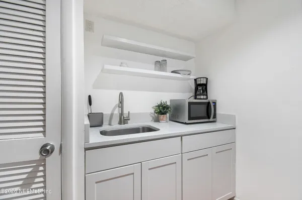 a kitchen with sink cabinets and appliances