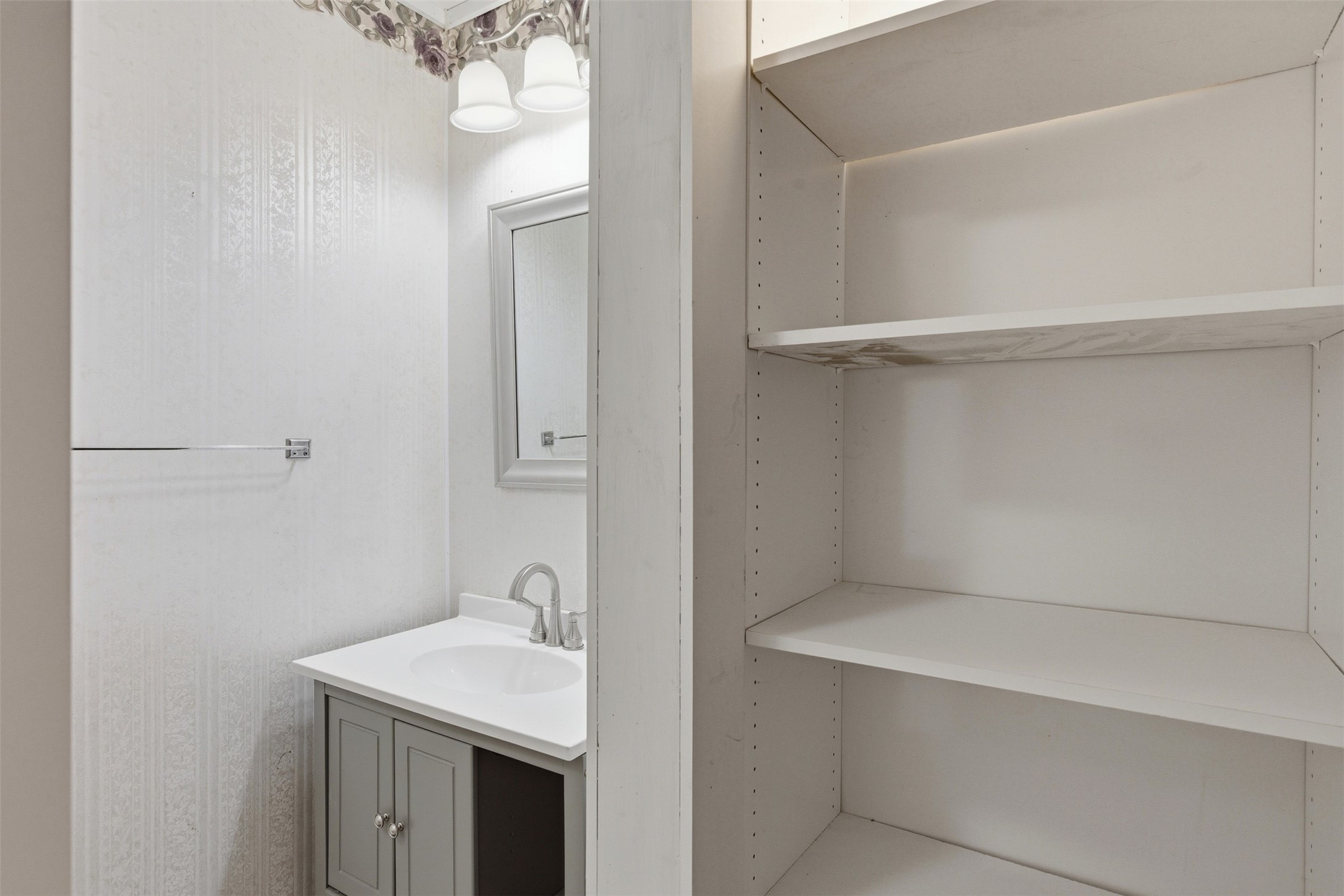 1310 Brazos Street Hempstead, TX 77445 - Photo 16 of 32 a bathroom with a sink and mirror