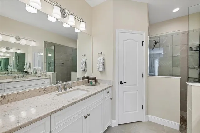 a view of an empty room with a window and chair