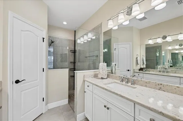 a bathroom with a granite countertop sink a toilet and a mirror