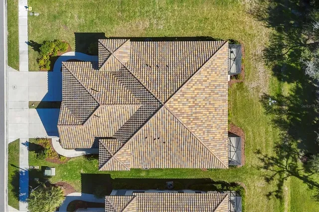an aerial view of residential houses with outdoor space and swimming pool