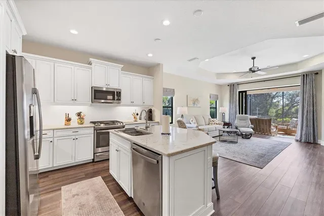 a kitchen with a sink stove cabinets and refrigerator