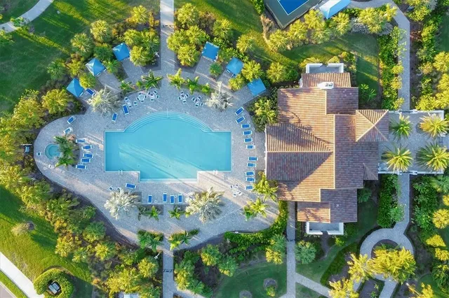 a view of a lake with lawn chairs and a big yard