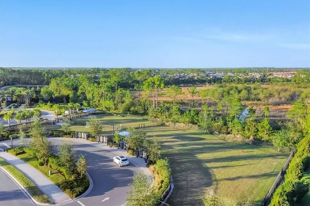 an aerial view of a golf course with a swimming pool