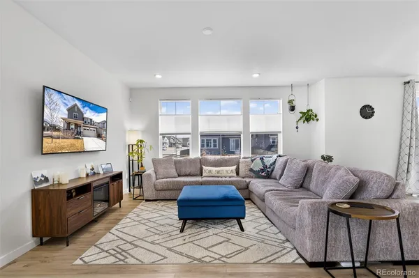 a living room with furniture a rug and a large window