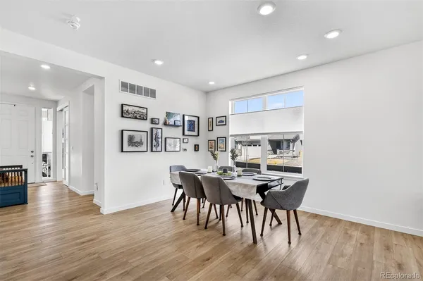 a view of a dining room with furniture and wooden floor