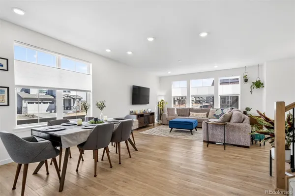 a living room with furniture wooden floor and a flat screen tv