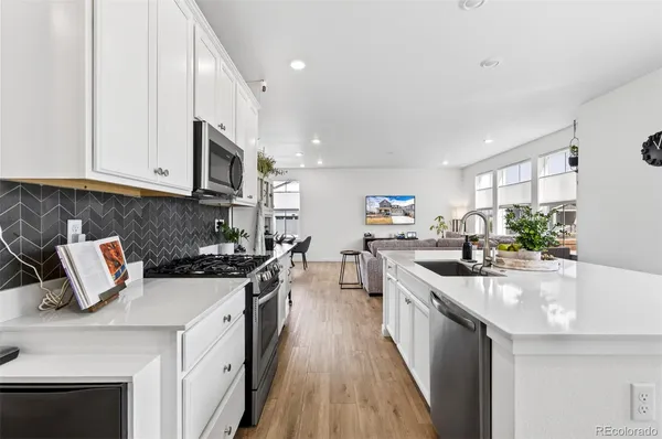 a kitchen with sink a stove and cabinets