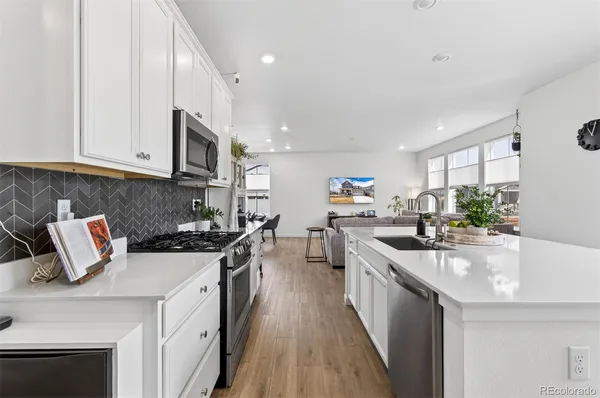 a kitchen with a sink a stove and cabinets