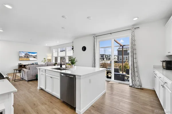 a kitchen with white cabinets stove and refrigerator