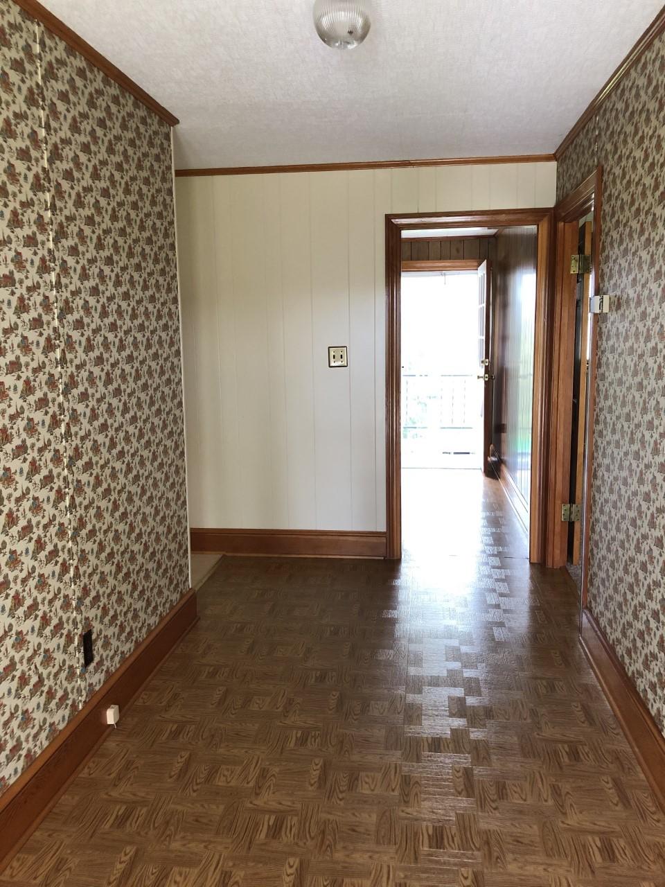 10091 Henry Road Henry, VA 24102 - Photo 12 of 40 a view of a hallway with wooden floor and a bathroom