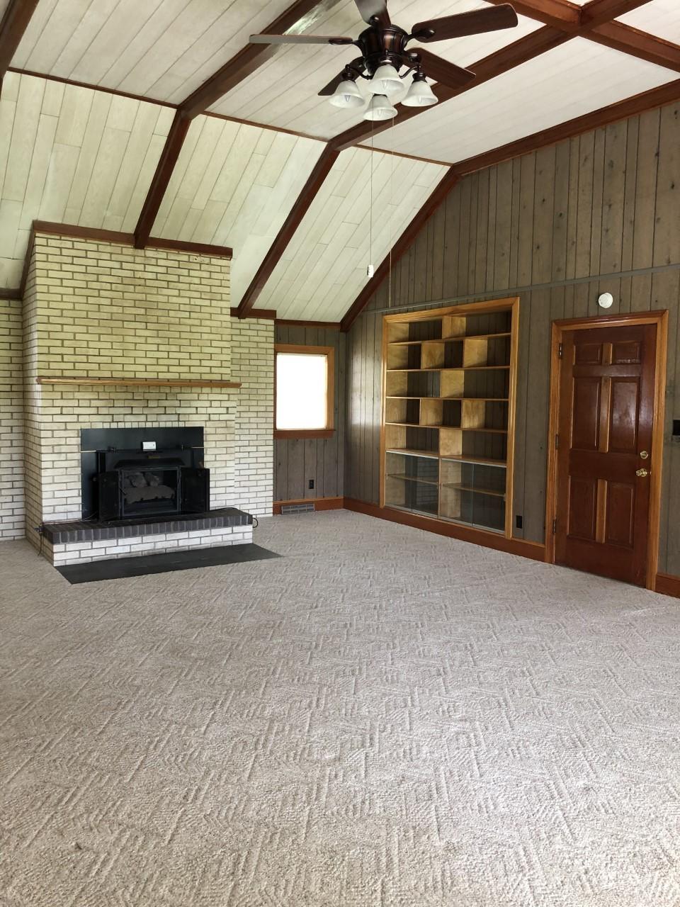 10091 Henry Road Henry, VA 24102 - Photo 13 of 40 an empty room with fireplace and fan