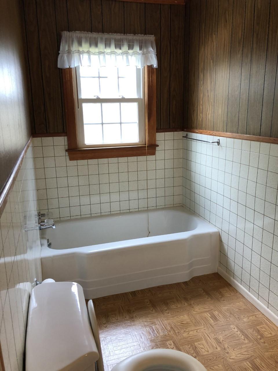 10091 Henry Road Henry, VA 24102 - Photo 27 of 40 a bathroom with a bathtub and window