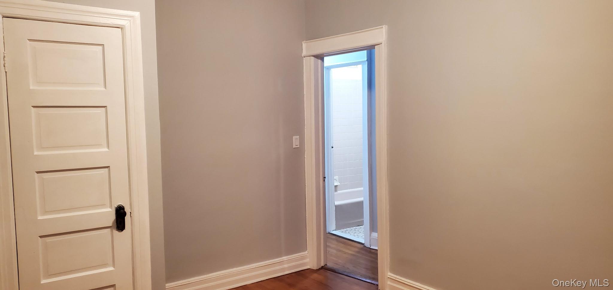 86-33 76th Street Queens, NY 11421 - Photo 12 of 13 a view of front door with wooden floor
