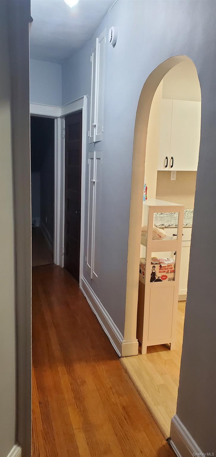 86-33 76th Street Queens, NY 11421 - Photo 3 of 13 an empty room with a mirror and a door