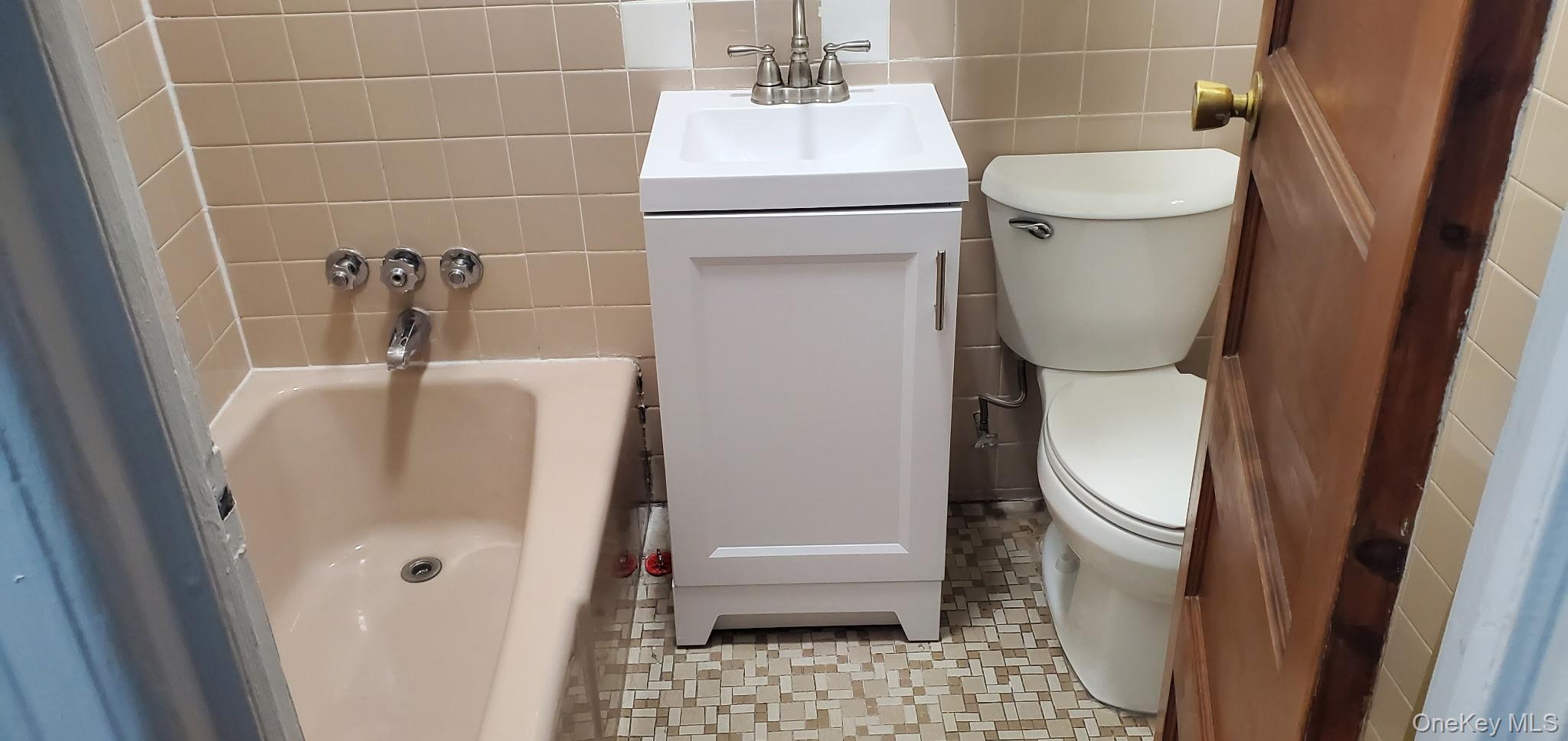 86-33 76th Street Queens, NY 11421 - Photo 5 of 13 a bathroom with a sink a toilet and shower