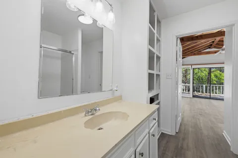 a bathroom with a sink a vanity and a mirror