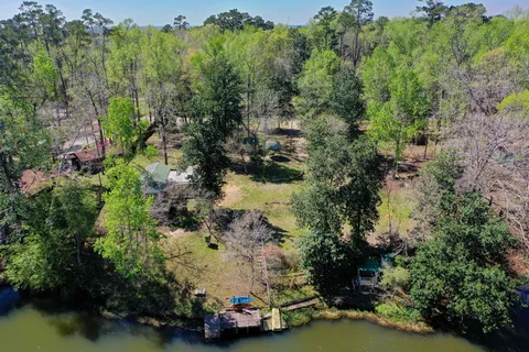 an aerial view of a houses with a yard