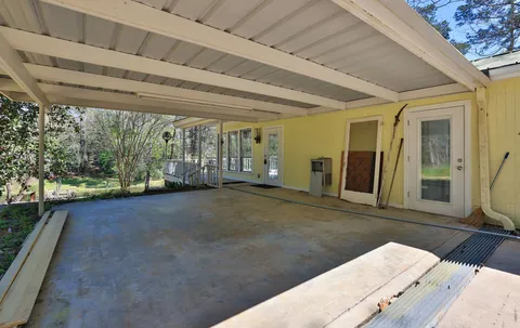 a view of backyard with tub and windows