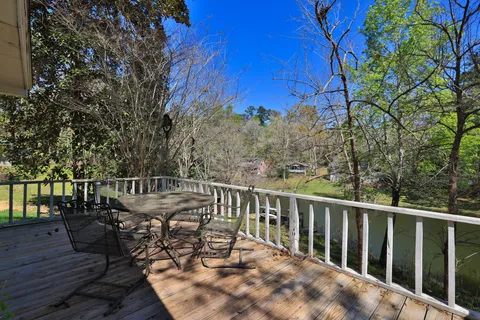 a view of a chairs and table on the wooden deck