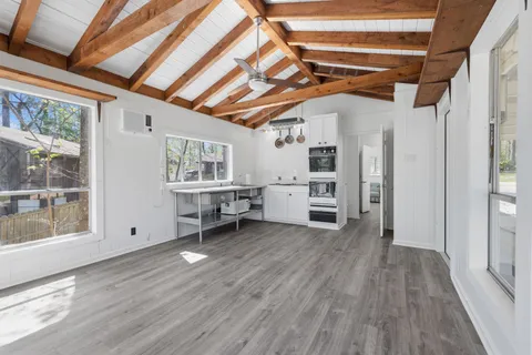 a view of a livingroom with hardwood and furniture